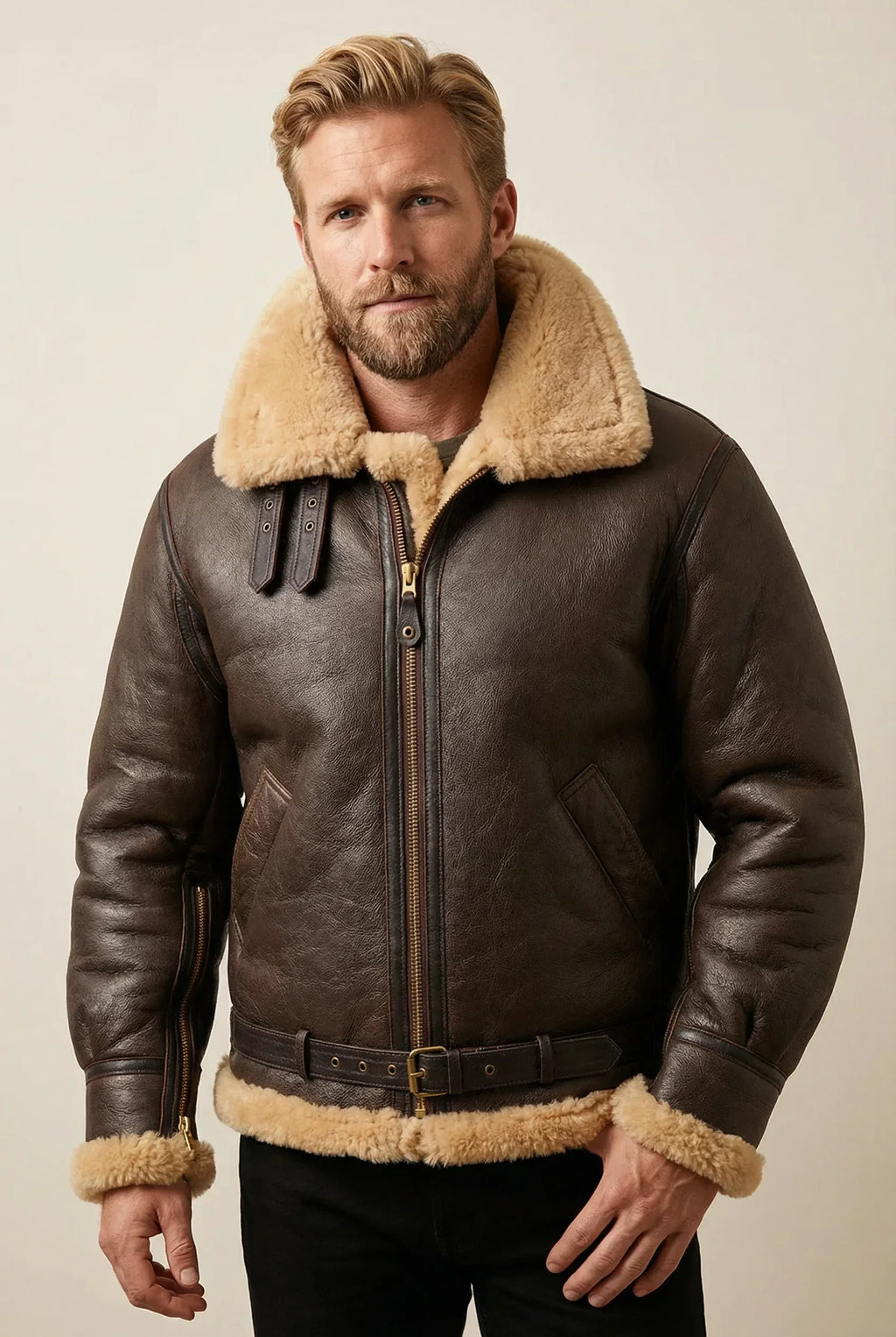 Brown and cream R.A.F Sheepskin bomber jacket worn by a blonde male model in a neutral studio setting.