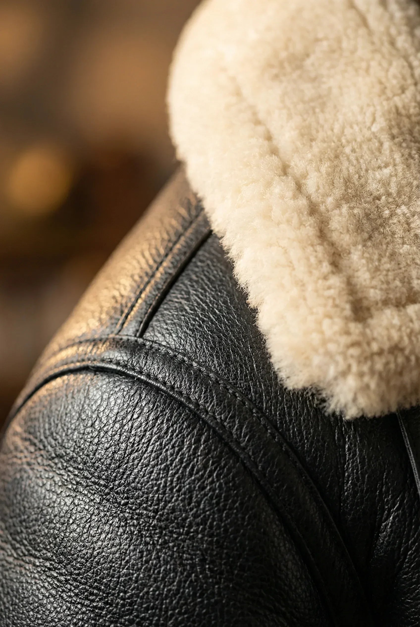 Close-up of Shearlord Black Cream B3 Bomber Jacket, highlighting the soft shearling texture and intricate stitching details.