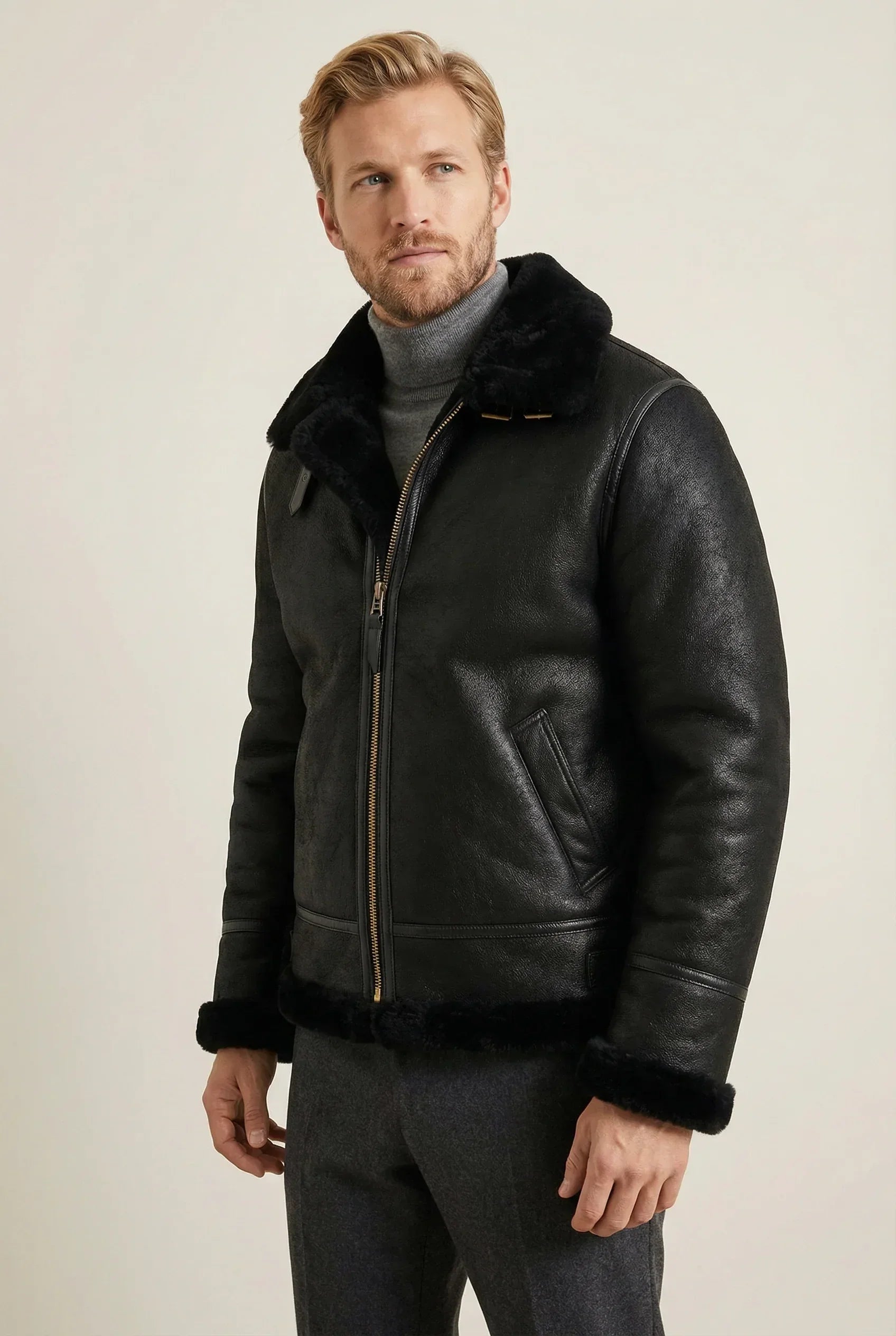 Shearlord classic black B-3 bomber jacket made of sheepskin, displayed against a soft neutral studio background.