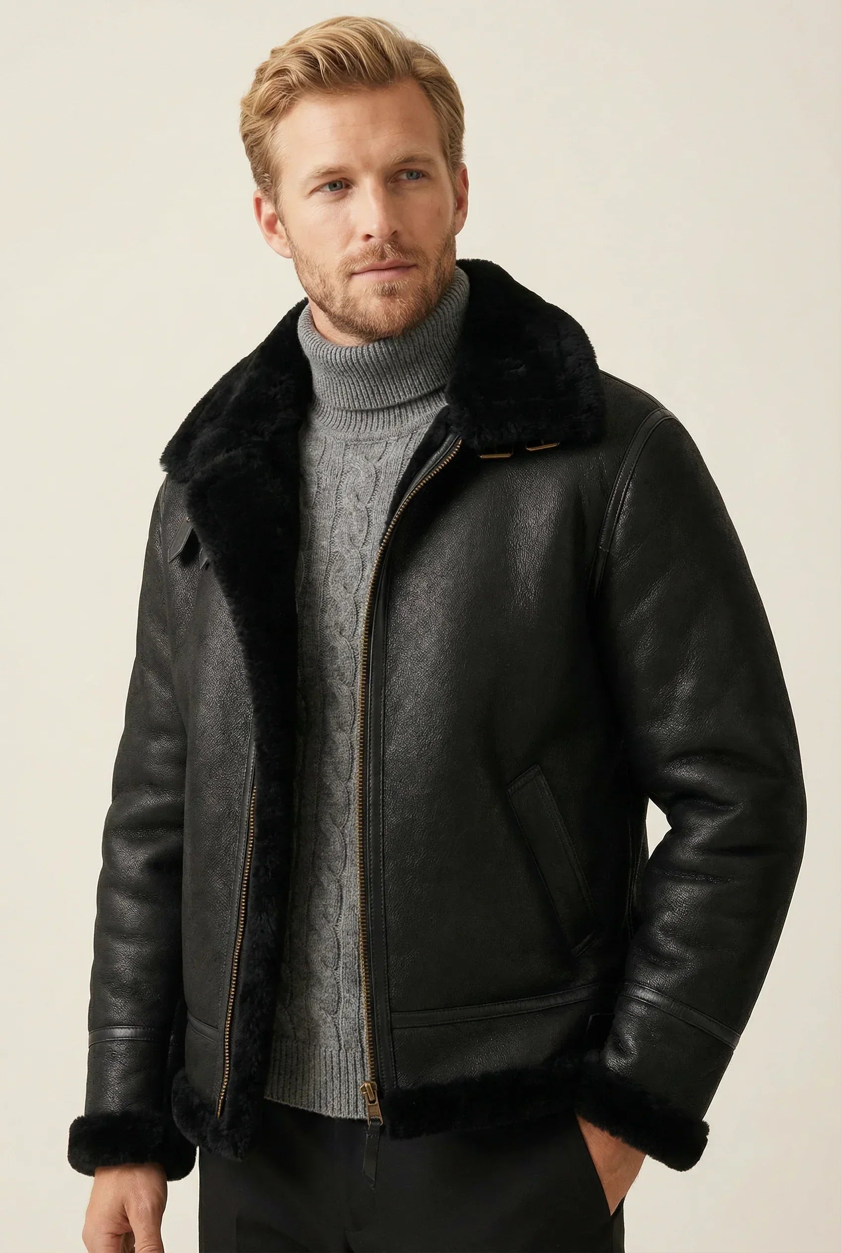 Black Shearlord Classic Sheepskin B-3 Bomber Jacket displayed in a soft neutral studio background with a matte finish.