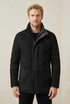 Black Shearlord Lucas shearling coat displayed on a neutral background, showcasing its soft texture and elegant design.