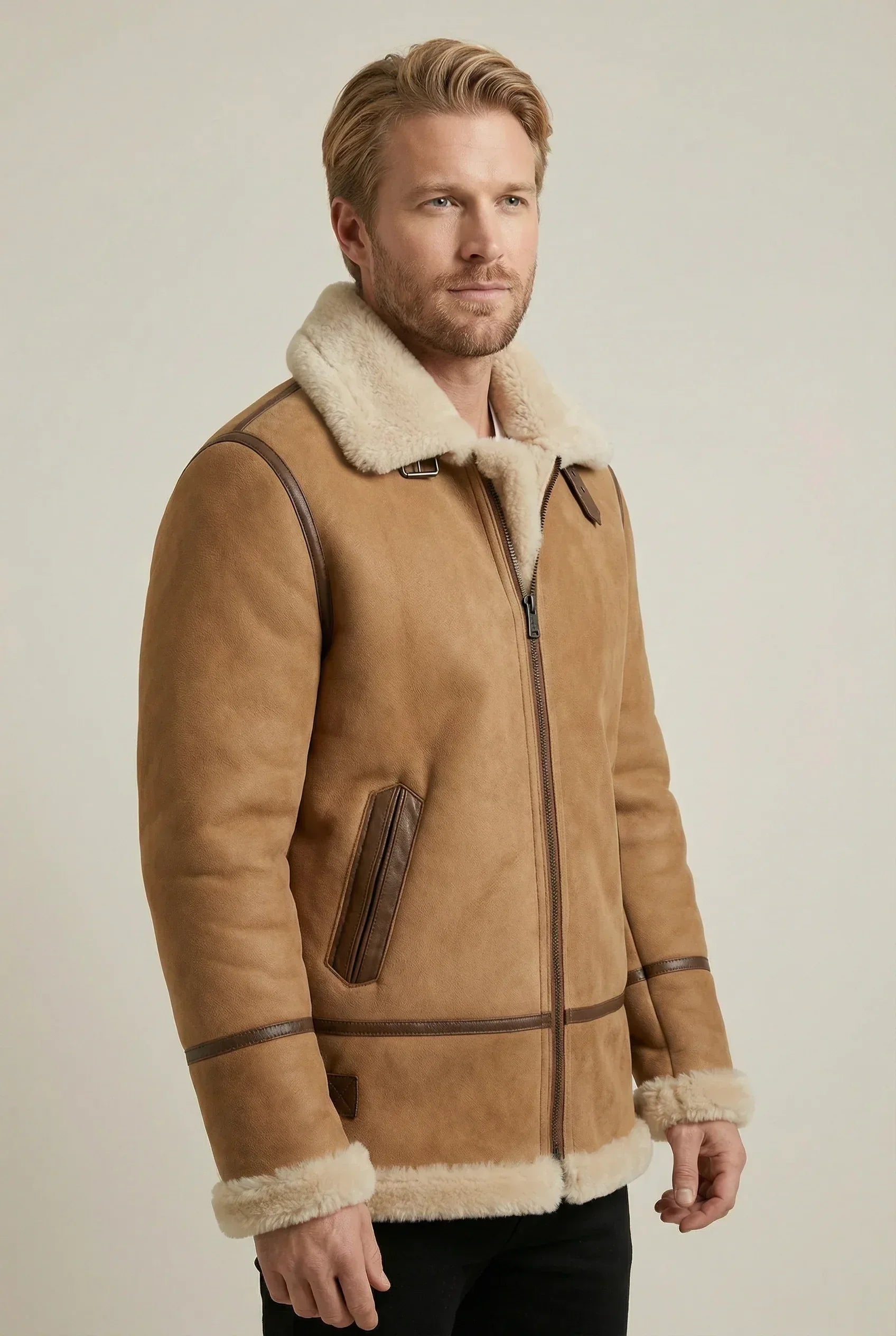 Shearlord whiskey cream B-3 bomber jacket made of soft sheepskin shearling against a neutral studio background.