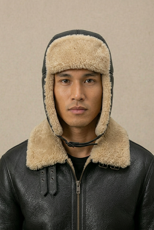 Black and cream sheepskin leather pilot hat by Shearlord with classic aviator style and padded ear flaps.